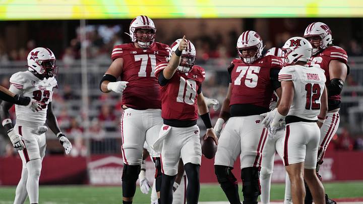 Aug 28, 2025; Madison, Wisconsin, USA;  Wisconsin Badgers quarterback Danny O'Neil (18) celebrates after earning a first down during the second quarter against the Miami (OH) RedHawks at Camp Randall Stadium. Mandatory Credit: Jeff Hanisch-Imagn Images