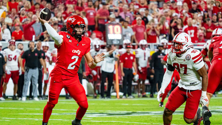 Aug 28, 2025; Kansas City, Missouri, USA; Cincinnati Bearcats quarterback Brendan Sorsby (2) passes against Nebraska Cornhuskers defensive lineman Keona Davis (97) during the second quarter at GEHA Field at Arrowhead Stadium. Mandatory Credit: Dylan Widger-Imagn Images