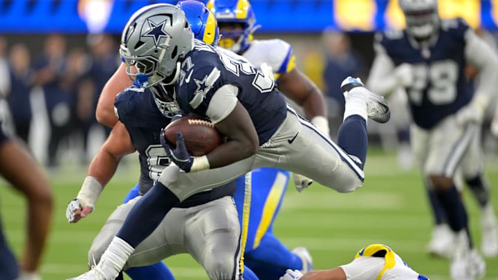Aug 9, 2025; Inglewood, California, USA;   Dallas Cowboys running back Phil Mafah (37) leaps over Los Angeles Rams safety Nate Valcarcel (43) for a first down during the second half at SoFi Stadium. Mandatory Credit: Jayne Kamin-Oncea-Imagn Images