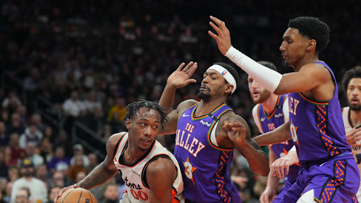 Dec 21, 2024; Phoenix, Arizona, USA; Detroit Pistons forward Ronald Holland II (00) protects the ball from Phoenix Suns defenders during the second half at Footprint Center. Mandatory Credit: Joe Camporeale-Imagn Images