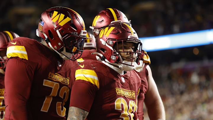 Washington Commanders running back Chris Rodriguez Jr. celebrates after scoring a touchdown.