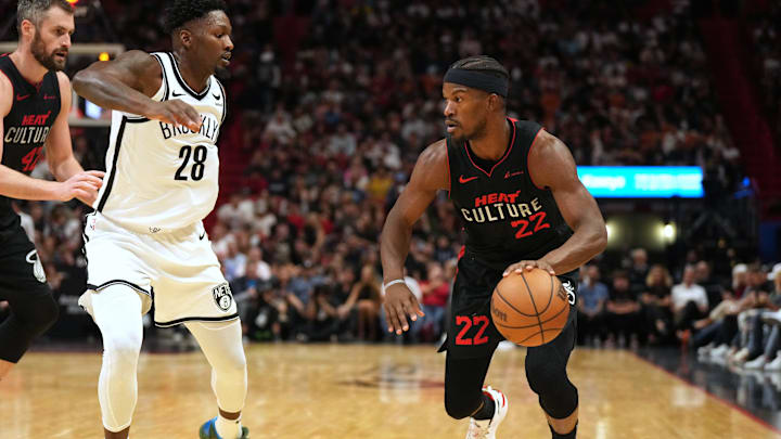 Nov 16, 2023; Miami, Florida, USA;  Miami Heat forward Jimmy Butler (22) drives to the basket as Brooklyn Nets forward Dorian Finney-Smith (28) defends in the first half at Kaseya Center. Mandatory Credit: Jim Rassol-Imagn Images