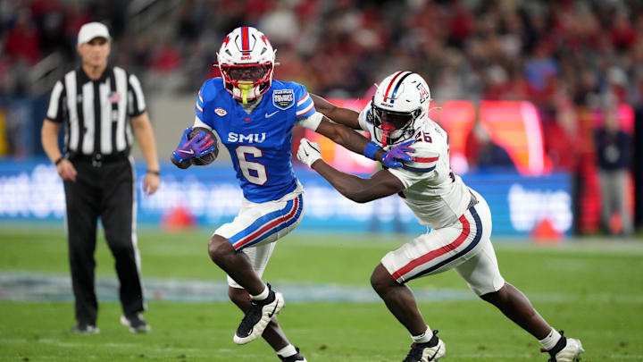 Jan 2, 2026; San Diego, CA, USA; SMU Mustangs running back Chris Johnson Jr. (6) carries the ball against Arizona Wildcats defensive back Coleman Patmon (26) in the first half during the Holiday Bowl at Snapdragon Stadium. Mandatory Credit: Kirby Lee-Imagn Images