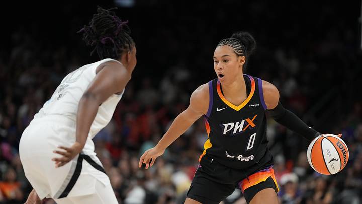 Aug 15, 2025; Phoenix, Arizona, USA; Phoenix Mercury forward Satou Sabally (0) drives on Las Vegas Aces guard Chelsea Gray (12) in the second half at Footprint Center. Mandatory Credit: Rick Scuteri-Imagn Images
