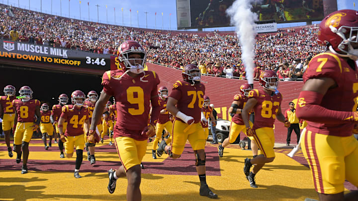 Oct 12, 2024; Los Angeles, California, USA;  USC Trojans players run on to United Airlines Field for the game against the Penn State Nittany Lions at the Los Angeles Memorial Coliseum. Mandatory Credit: Jayne Kamin-Oncea-Imagn Images