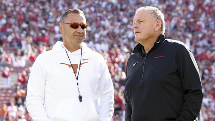 Nov 16, 2024; Fayetteville, Arkansas, USA; Texas Longhorns head coach Steve Sarkisian and Arkansas Razorbacks head coach Sam Pittman interact prior to the game at Donald W. Reynolds Razorback Stadium. Mandatory Credit: Nelson Chenault-Imagn Images