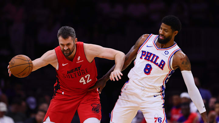 Nov 18, 2024; Miami, Florida, USA; Miami Heat forward Kevin Love (42) protects the basketball from Philadelphia 76ers forward Paul George (8) during the first quarter at Kaseya Center. Mandatory Credit: Sam Navarro-Imagn Images