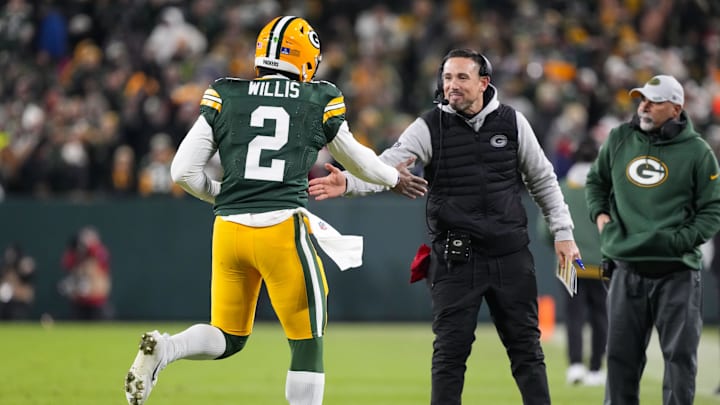 Dec 23, 2024; Green Bay, Wisconsin, USA;  Green Bay Packers head coach Matt LaFleur greets quarterback Malik Willis (2) following a touchdown during the fourth quarter against the New Orleans Saints at Lambeau Field. Mandatory Credit: Jeff Hanisch-Imagn Images
