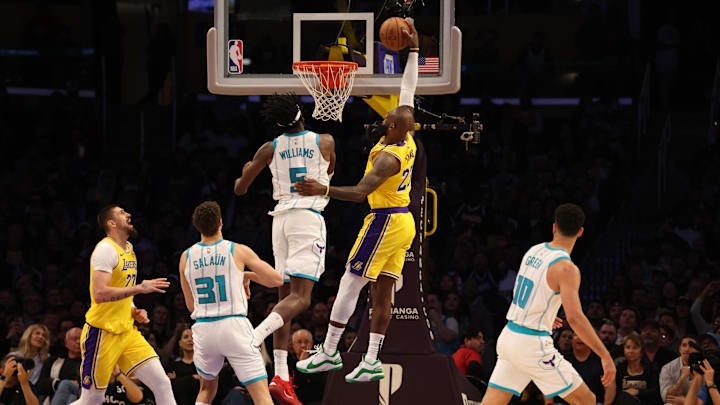 Feb 19, 2025; Los Angeles, California, USA; Los Angeles Lakers forward LeBron James (23) dunks against Charlotte Hornets center Mark Williams (5) during the fourth quarter at Crypto.com Arena. Mandatory Credit: Jason Parkhurst-Imagn Images