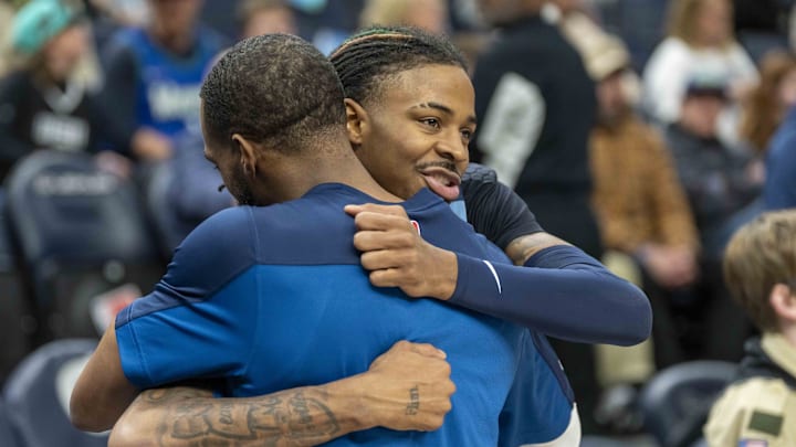 Jan 11, 2025; Minneapolis, Minnesota, USA; Memphis Grizzlies guard Ja Morant (12) and Minnesota Timberwolves guard Mike Conley (10) hug before a game at Target Center. Mandatory Credit: Jesse Johnson-Imagn Images