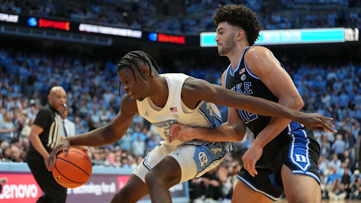 Feb 7, 2026; Chapel Hill, North Carolina, USA; North Carolina Tar Heels forward Caleb Wilson (8) with the ball as Duke Blue Devils forward Cameron Boozer (12) defends.