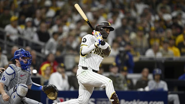 Oct 9, 2024; San Diego, California, USA; San Diego Padres outfielder Jurickson Profar (10) singles in the eighth inning against the Los Angeles Dodgers during game four of the NLDS for the 2024 MLB Playoffs at Petco Park.  Mandatory Credit: Denis Poroy-Imagn Images