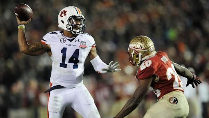 Auburn quarterback Nick Marshall (14) gets a pass away while defended by Florida State defenscive back Lamarcus Joyner (20) in second half action of the BCS National Championship Game on Monday January 6, 2014 in Pasadena, Ca.