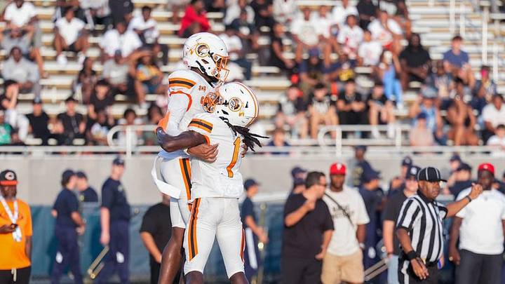Carol City's Za'Kari Johnson (left), a Florida State commit, plays in a preseason Kickoff Classic game against West Boca Raton on Friday, Aug. 14, 2026 in Boca Raton.