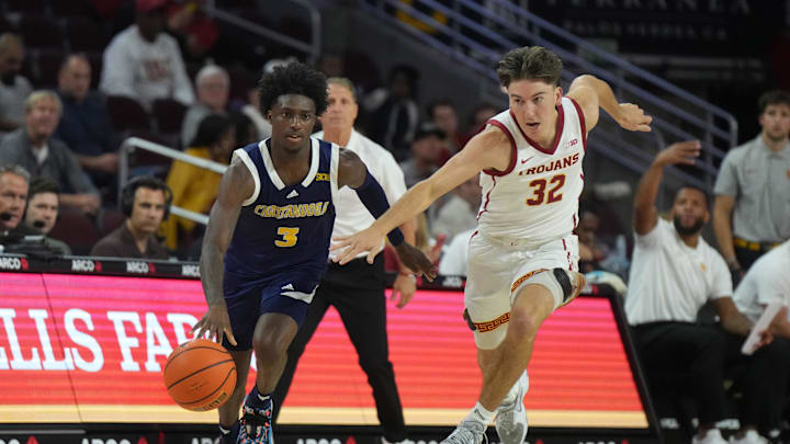 Nov 4, 2024; Los Angeles, California, USA; Chattanooga Mocs guard Honor Huff (3) dribbles the ball against Southern California Trojans guard Clark Slajchert (32) in the second half at Galen Center. Mandatory Credit: Kirby Lee-Imagn Images