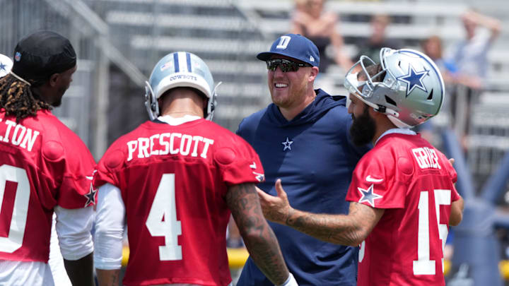 Jul 22, 2025; Oxnard, CA, USA; Dallas Cowboys quarterbacks coach Steve Shimko talks with quarterbacks Joe Milton III (10), Dak Prescott (4) and Will Grier (15) during training camp at the River Ridge Fields. Mandatory Credit: Kirby Lee-Imagn Images