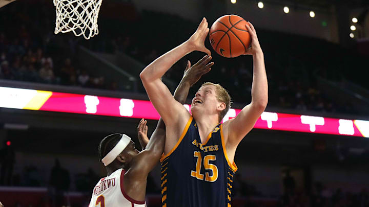 Nov 14, 2023; Los Angeles, California, USA; UC Irvine Anteaters center Bent Leuchten (15) shoots the ball against Southern California Trojans forward Vincent Iwuchukwu (3)  in the first half at Galen Center. Mandatory Credit: Kirby Lee-Imagn Images