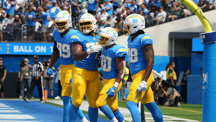 Sep 10, 2023; Inglewood, California, USA; Los Angeles Chargers running back Austin Ekeler (30) celebrates with tight end Donald Parham Jr. (89), guard Zion Johnson (77) and tight end Tre' McKitty (88) after scoring on a 1-yard touchdown run in the first half against the Miami Dolphins at SoFi Stadium. Mandatory Credit: Kirby Lee-Imagn Images