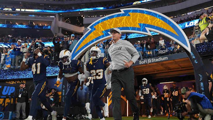 Nov 25, 2024; Inglewood, California, USA; Los Angeles Chargers coach Jim Harbaugh and cornerback Eli Apple (41) and wide receiver Joshua Palmer (5) and safety Tony Jefferson (23) enter the field before the game against the Baltimore Ravens at SoFi Stadium. 