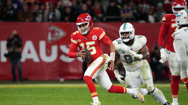Nov 5, 2023; Frankfurt, Germany; Kansas City Chiefs quarterback Patrick Mahomes (15) is pursued by Miami Dolphins defensive tackle Christian Wilkins (94) in the first half during an NFL International Series game at Deutsche Bank Park. Mandatory Credit: Kirby Lee-Imagn Images