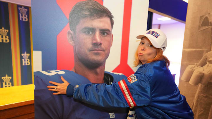 Nov 9, 2024; Munich, Germany; New York Giants fan Marianne Denning poses with image of quarterback Daniel Jones at the Giants team pub at Hofbrauhaus. Mandatory Credit: Kirby Lee-Imagn Images