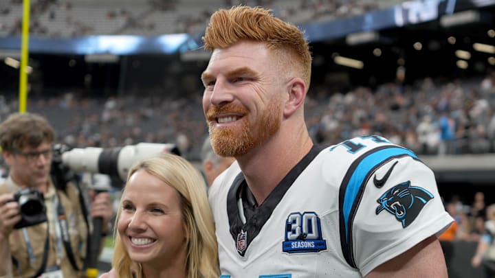 Sep 22, 2024; Paradise, Nevada, USA; Carolina Panthers quarterback Andy Dalton (14) poses with his wife Jordan Dalton before the game against the Las Vegas Raiders at Allegiant Stadium. Mandatory Credit: Kirby Lee-Imagn Images