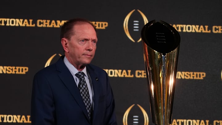 Jan 9, 2024; Houston, TX, USA; College Football Playoff senior director of communications Brett Daniels poses with CFP National Championship trophy at press conference at JW Marriot Houston by the Galleria. Mandatory Credit: Kirby Lee-USA TODAY Sports