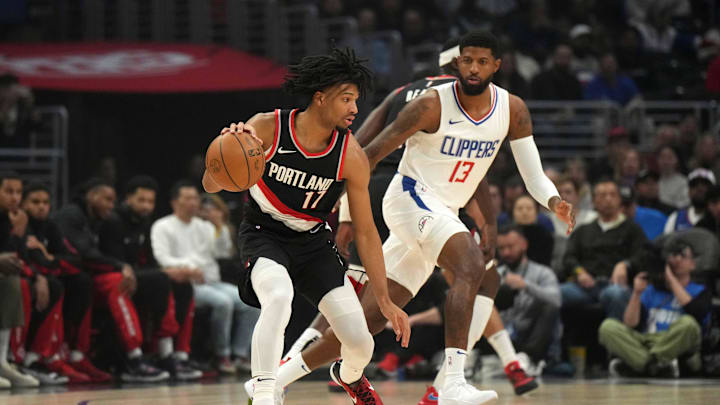 Dec 11, 2023; Los Angeles, California, USA;Portland Trail Blazers guard Shaedon Sharpe (17) dribbles against LA Clippers forward Paul George (13) in the first half at Crypto.com Arena. Mandatory Credit: Kirby Lee-USA TODAY Sports