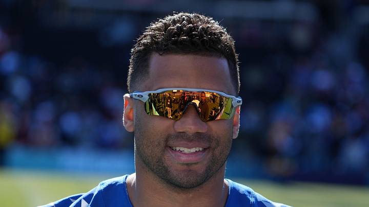 Former Seattle Seahawks quarterback Russell Wilson practices with a smile
