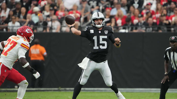 Oct 27, 2024; Paradise, Nevada, USA; Las Vegas Raiders quarterback Gardner Minshew (15) throws the ball against Kansas City Chiefs safety Chamarri Conner (27) in the first half at Allegiant Stadium. Mandatory Credit: Kirby Lee-Imagn Images