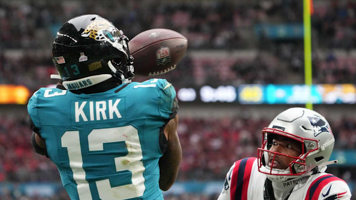 Oct 20, 2024; London, United Kingdom; Jacksonville Jaguars wide receiver Christian Kirk (13) attempts to catch the ball against New England Patriots cornerback Marcus Jones (25) in the second half of an NFL International Series game at Wembley Stadium. Mandatory Credit: Kirby Lee-Imagn Images