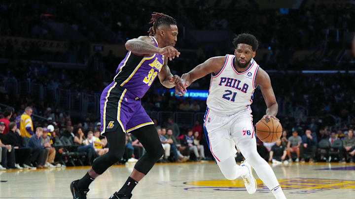Mar 23, 2022; Los Angeles, California, USA; Philadelphia 76ers center Joel Embiid (21) is defended by Los Angeles Lakers center Dwight Howard (39) in the first half at Crypto.com Arena. Mandatory Credit: Kirby Lee-Imagn Images