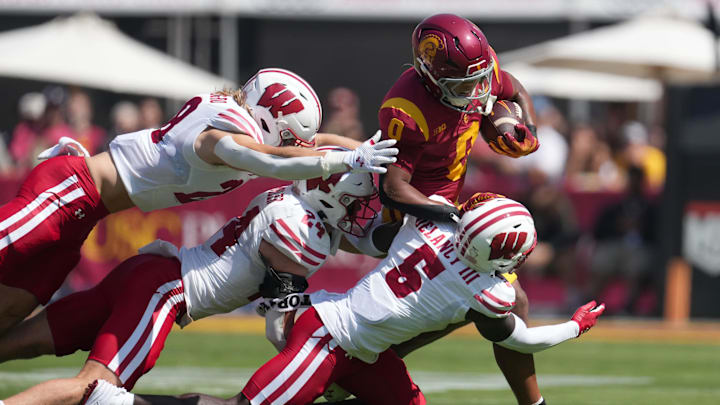 Sep 28, 2024; Los Angeles, California, USA; Southern California Trojans wide receiver Ja'Kobi Lane (8) runs against Wisconsin Badgers linebacker Christian Alliegro (28), safety Hunter Wohler (24) and cornerback RJ Delancy III (5) in the first half at United Airlines Field at Los Angeles Memorial Coliseum. Sep 28, 2024; Los Angeles, California, USA; Southern California Trojans wide receiver Ja'Kobi Lane (8) runs against Wisconsin Badgers linebacker Christian Alliegro (28), safety Hunter Wohler (24) and cornerback RJ Delancy III (5) in the first half at United Airlines Field at Los Angeles Memorial Coliseum.