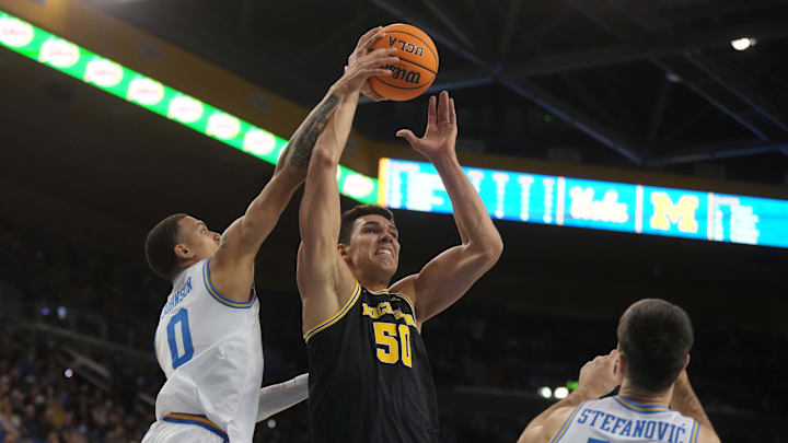 Jan 7, 2025; Los Angeles, California, USA; Michigan Wolverines center Vladislav Goldin (50) shoots the ball against UCLA Bruins guard Kobe Johnson (0) and guard Lazar Stefanovic (10) in the first half at Pauley Pavilion presented by Wescom. Mandatory Credit: Kirby Lee-Imagn Images Jan 7, 2025; Los Angeles, California, USA; Michigan Wolverines center Vladislav Goldin (50) shoots the ball against UCLA Bruins guard Kobe Johnson (0) and guard Lazar Stefanovic (10) in the first half at Pauley Pavilion presented by Wescom. Mandatory Credit: Kirby Lee-Imagn Images