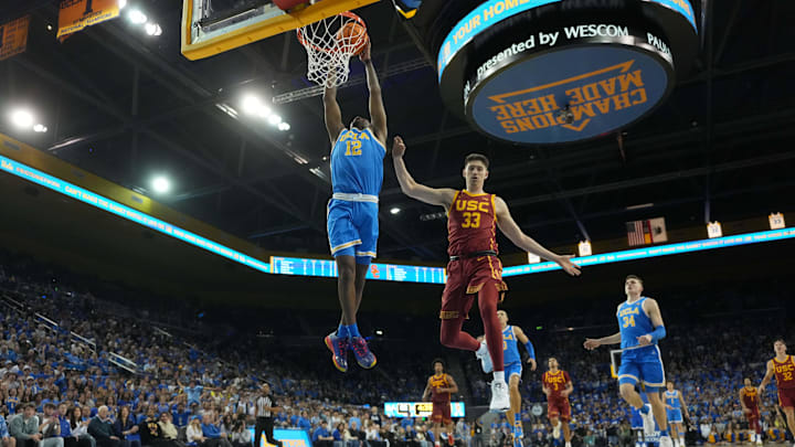 Mar 8, 2025; Los Angeles, California, USA; UCLA Bruins guard Sebastian Mack (12) dunks the ball against Southern California Trojans forward Josh Cohen (33) in the second half at Pauley Pavilion presented by Wescom. Mandatory Credit: Kirby Lee-Imagn Images