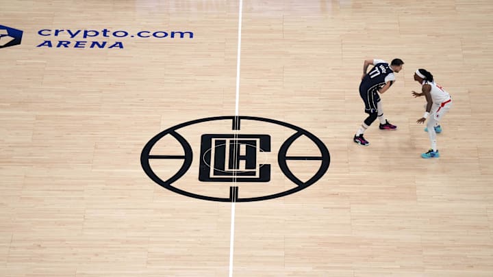 May 1, 2024; Los Angeles, California, USA; A general overall view as Dallas Mavericks guard Luka Doncic (77) is defended by LA Clippers guard Terance Mann (14) near the Clippers logo at midcourt in the first half during game five of the first round for the 2024 NBA playoffs at Crypto.com Arena. Mandatory Credit: Kirby Lee-USA TODAY Sports