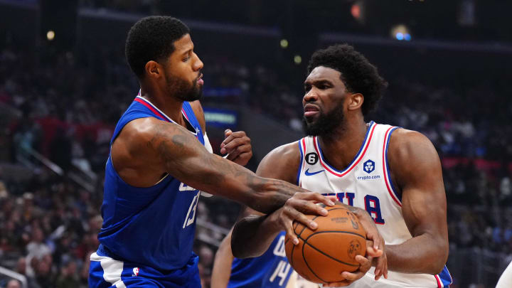 Jan 17, 2023; Los Angeles, California, USA; Philadelphia 76ers center Joel Embiid (21) is fouled by LA Clippers guard Paul George (13) in the first half at Crypto.com Arena. Mandatory Credit: Kirby Lee-USA TODAY Sports