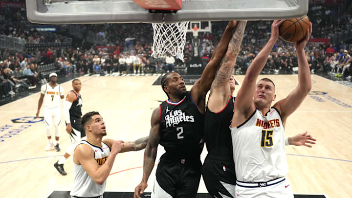 Denver Nuggets center Nikola Jokic (15) shoots the ball against LA Clippers forward Kawhi Leonard (2) and center Ivica Zubac (40) in the first half at Crypto.com Arena. Mandatory Credit: Kirby Lee-Imagn Images