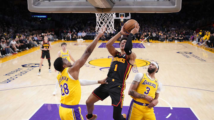 Mar 18, 2024; Los Angeles, California, USA; Atlanta Hawks forward Jalen Johnson (1) shoots the ball against Los Angeles Lakers forward Rui Hachimura (28)] and forward Anthony Davis (3) in the first half at Crypto.com Arena. Mandatory Credit: Kirby Lee-Imagn Images