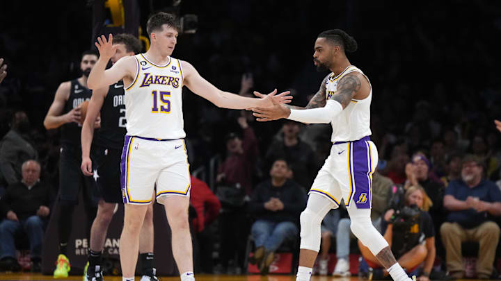 Mar 19, 2023; Los Angeles, California, USA; Los Angeles Lakers guard Austin Reaves (15) and guard D'Angelo Russell (1) celebrate against the Orlando Magic in the first half at Crypto.com Arena. Mandatory Credit: Kirby Lee-Imagn Images