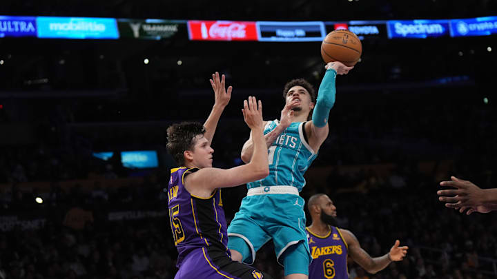 Dec 23, 2022; Los Angeles, California, USA; Charlotte Hornets guard LaMelo Ball (1) shoots the ball against Los Angeles Lakers guard Austin Reaves (15) in the first half at Crypto.com Arena. Mandatory Credit: Kirby Lee-Imagn Images