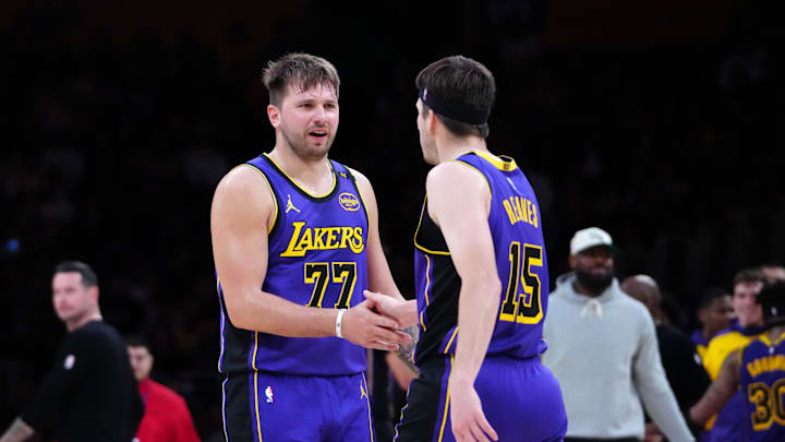 Mar 17, 2025; Los Angeles, California, USA; Los Angeles Lakers guard Luka Doncic (77) and guard Austin Reaves (15) react against the San Antonio Spurs in the first half at Crypto.com Arena. Mandatory Credit: Kirby Lee-Imagn Images