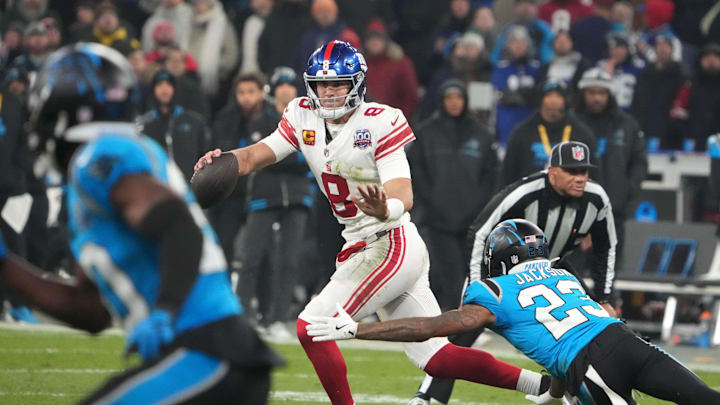 Nov 10, 2024; Munich, Germany; New York Giants quarterback Daniel Jones (8) is pressured by Carolina Panthers cornerback Dane Jackson (23) in the second half during the 2024 NFL Munich Game at Allianz Arena. Mandatory Credit: Kirby Lee-Imagn Images