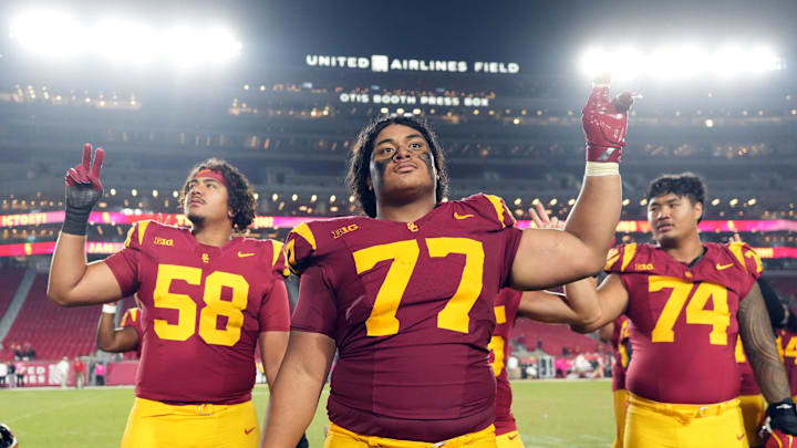 Oct 25, 2024; Los Angeles, California, USA; Southern California Trojans offensive lineman Alani Noa (77) celebrates with teammates after the game against the Rutgers Scarlet Knights at United Airlines Field at Los Angeles Memorial Coliseum. Mandatory Credit: Kirby Lee-Imagn Images