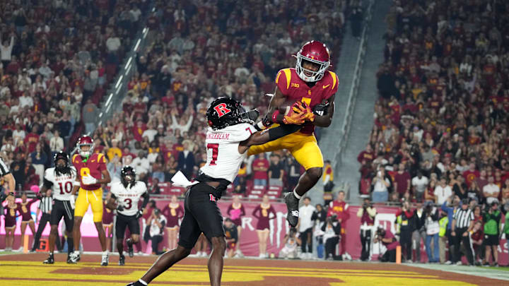 Oct 25, 2024; Los Angeles, California, USA; Southern California Trojans wide receiver Zachariah Branch (1) attempts to catch the ball against Rutgers Scarlet Knights defensive back Robert Longerbeam (7) in the first half at United Airlines Field at Los Angeles Memorial Coliseum. Mandatory Credit: Kirby Lee-Imagn Images