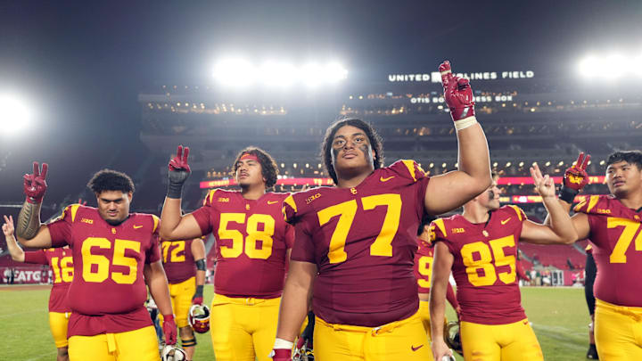 Oct 25, 2024; Los Angeles, California, USA; Southern California Trojans offensive lineman Alani Noa (77) celebrates with teammates after the game against the Rutgers Scarlet Knights at United Airlines Field at Los Angeles Memorial Coliseum. Mandatory Credit: Kirby Lee-Imagn Images