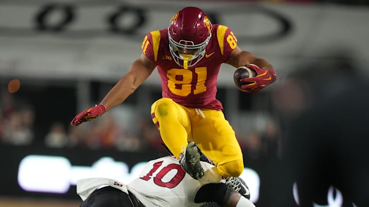 Oct 25, 2024; Los Angeles, California, USA; Southern California Trojans wide receiver Kyle Ford (81) hurdles Rutgers Scarlet Knights defensive back Flip Dixon (10) in the first half at United Airlines Field at Los Angeles Memorial Coliseum. Mandatory Credit: Kirby Lee-Imagn Images