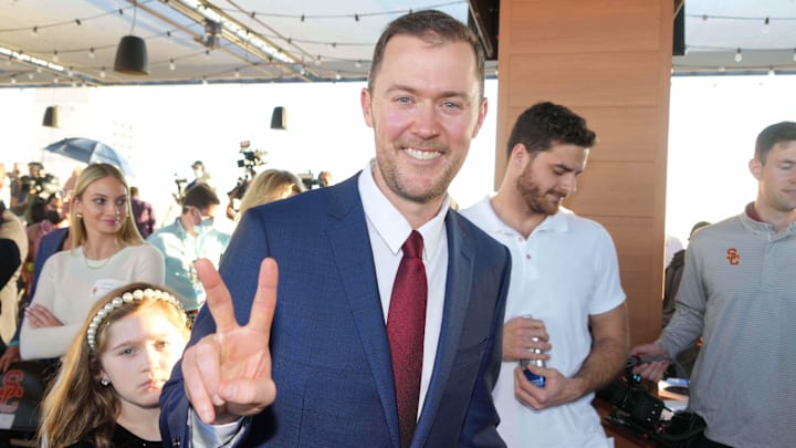 Nov 29, 2021; Los Angeles, CA, USA; Lincoln Riley poses with Fight on sign during a press conference to introduce Riley as Southern California Trojans head coach. Mandatory Credit: Kirby Lee-Imagn Images