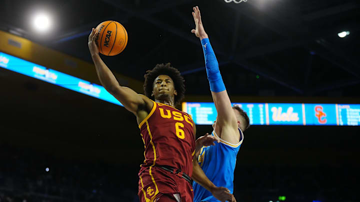 Mar 8, 2025; Los Angeles, California, USA; Southern California Trojans guard Wesley Yates III (6) shoots against UCLA Bruins forward Tyler Bilodeau (34) in the first half at Pauley Pavilion presented by Wescom. Mandatory Credit: Kirby Lee-Imagn Images