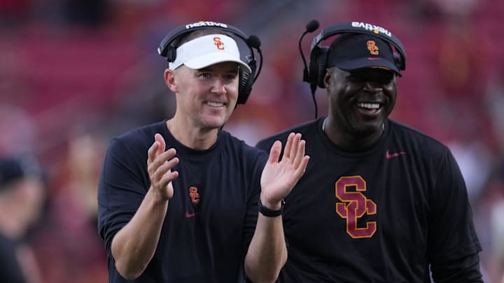 Sep 2, 2023; Los Angeles, California, USA; Southern California Trojans head coach Lincoln Riley (leff) and wide receivers coach Dennis Simmons react against the Nevada Wolf Pack in the second half at United Airlines Field at Los Angeles Memorial Coliseum. Mandatory Credit: Kirby Lee-Imagn Images